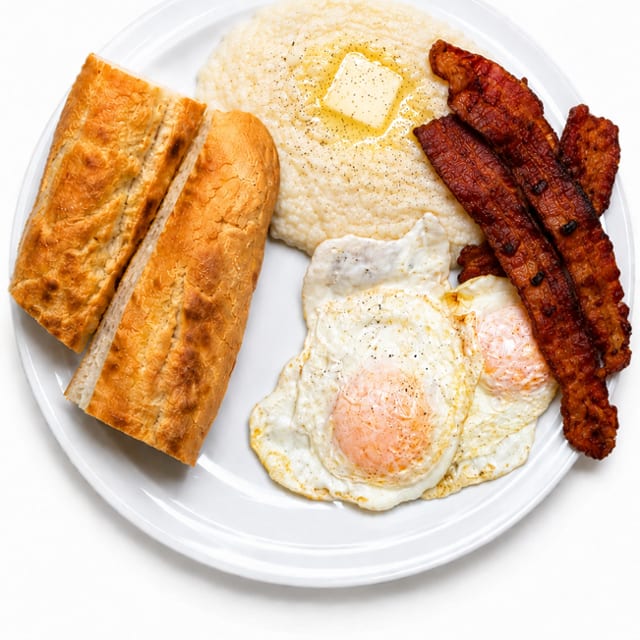 2 Eggs with Meat, Grits or Home Fries & Cuban Toast Platter.